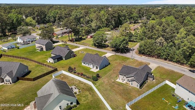 birds eye view of property with a residential view and a view of trees