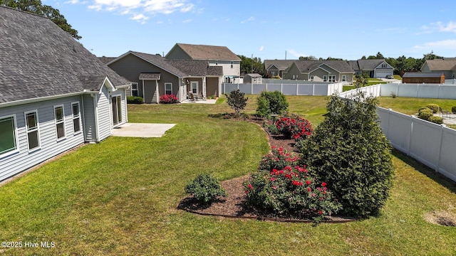 view of yard with a residential view and a fenced backyard