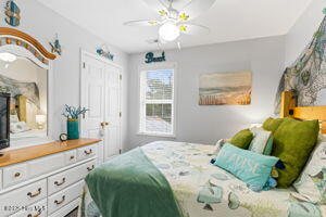 124 NE 15th St, Oak Island, NC 28465 - bedroom featuring ceiling fan