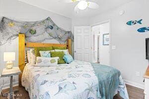 124 NE 15th St, Oak Island, NC 28465 - bedroom with baseboards, a ceiling fan, and wood finished floors