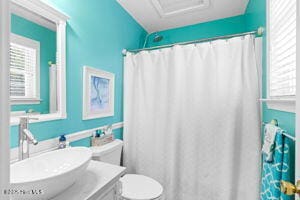 124 NE 15th St, Oak Island, NC 28465 - bathroom with vanity, toilet, and a shower with shower curtain