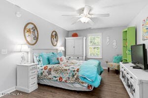 124 NE 15th St, Oak Island, NC 28465 - bedroom featuring baseboards, dark wood-type flooring, and a ceiling fan