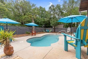 124 NE 15th St, Oak Island, NC 28465 - view of pool with a patio, a fenced in pool, and a fenced backyard