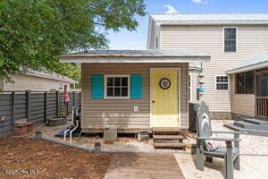 124 NE 15th St, Oak Island, NC 28465 - rear view of house with an outbuilding and a fenced backyard
