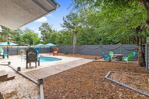 124 NE 15th St, Oak Island, NC 28465 - view of pool featuring a patio area, a fenced in pool, and a fenced backyard