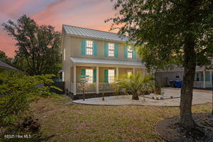 124 NE 15th St, Oak Island, NC 28465 - traditional-style house featuring covered porch and metal roof