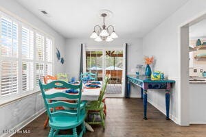 124 NE 15th St, Oak Island, NC 28465 - dining area featuring plenty of natural light, wood finished floors, and a notable chandelier