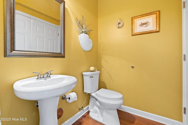 7610 High Market St Unit 3, Sunset Beach, NC 28468 - bathroom with toilet, baseboards, wood finished floors, and a sink