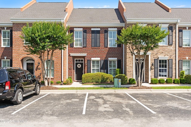 7610 High Market St Unit 3, Sunset Beach, NC 28468 - view of property with uncovered parking, brick siding, and a shingled roof