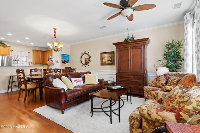 7610 High Market St Unit 3, Sunset Beach, NC 28468 - living area with light wood-style floors, ceiling fan, crown molding, a chandelier, and wainscoting