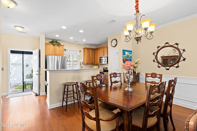 7610 High Market St Unit 3, Sunset Beach, NC 28468 - dining space with a chandelier, dark wood-style floors, recessed lighting, ornamental molding, and baseboards