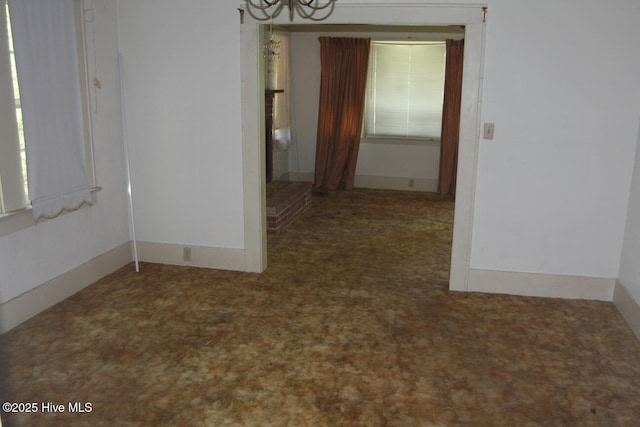 spare room featuring an inviting chandelier