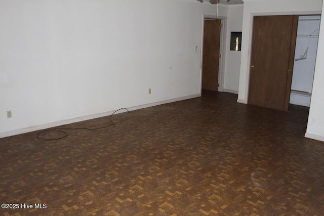 spare room with baseboards