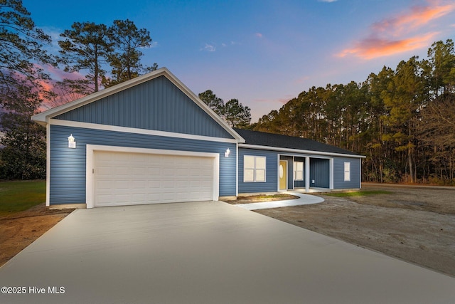 single story home featuring a garage and driveway
