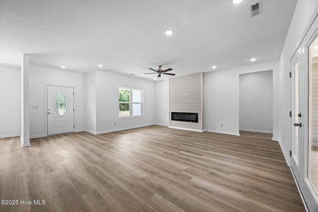 2594 Fountaintown Rd, Chinquapin, NC 28521 - kitchen featuring stainless steel appliances, light wood-type flooring, dark stone countertops, white cabinets, and recessed lighting