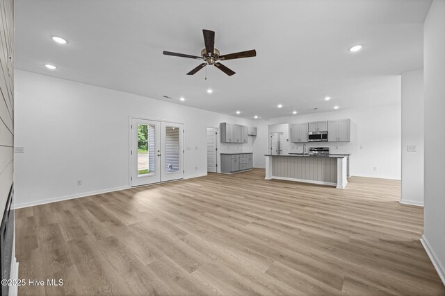 2594 Fountaintown Rd, Chinquapin, NC 28521 - kitchen with stainless steel appliances, light wood-style flooring, white cabinets, an island with sink, and recessed lighting