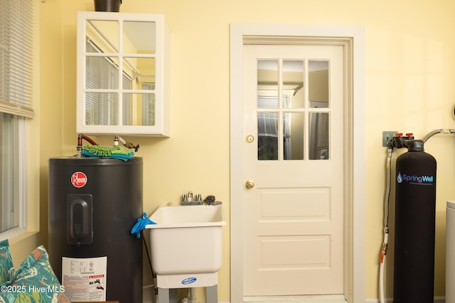505 N Broad St, Edenton, NC 27932 - doorway to outside featuring water heater and a sink