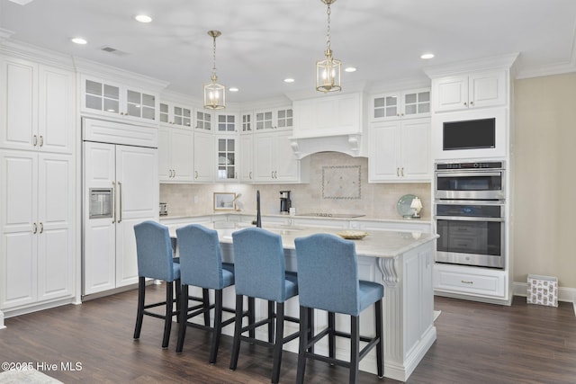 kitchen with double oven, white cabinets, and dark wood-type flooring