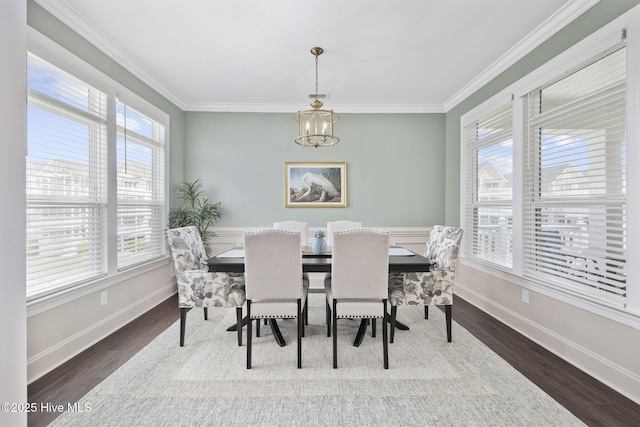 dining area featuring a wealth of natural light, a notable chandelier, and baseboards