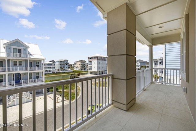 balcony featuring a water view and a residential view