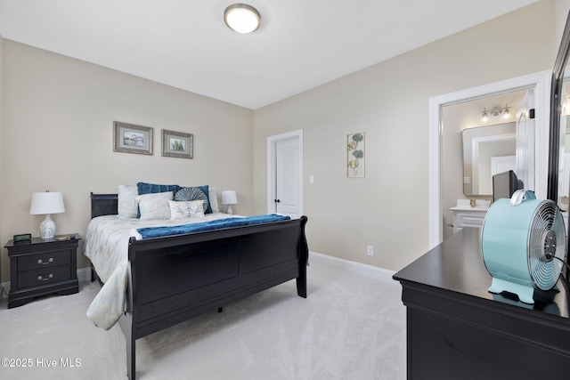 bedroom with baseboards and light carpet