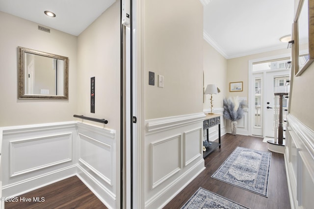 interior space with recessed lighting, a decorative wall, a wainscoted wall, dark wood-style floors, and crown molding