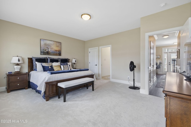 bedroom with baseboards and light colored carpet
