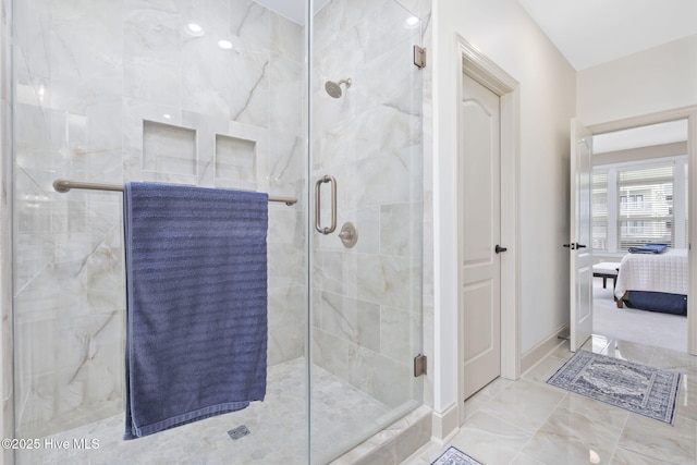 full bathroom with baseboards, a shower stall, connected bathroom, and marble finish floor
