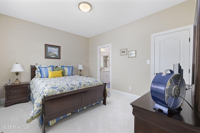 bedroom featuring light colored carpet, ensuite bathroom, and baseboards