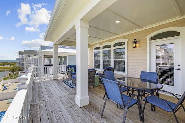 deck featuring an outdoor living space and outdoor dining space