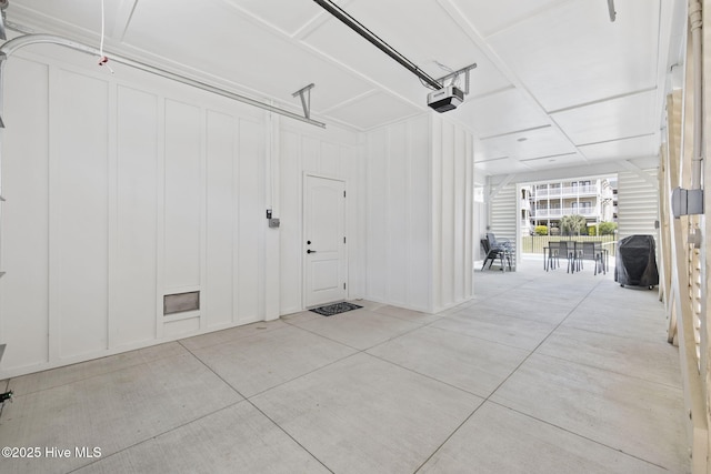 garage featuring a garage door opener and a decorative wall