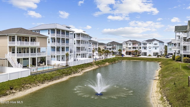 property view of water featuring fence and a residential view