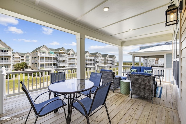 wooden terrace with outdoor lounge area, a residential view, and outdoor dining area