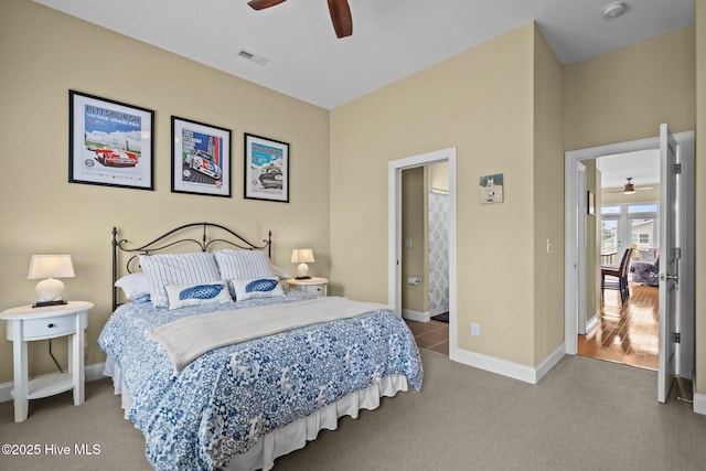 bedroom with ensuite bath, ceiling fan, carpet flooring, baseboards, and visible vents