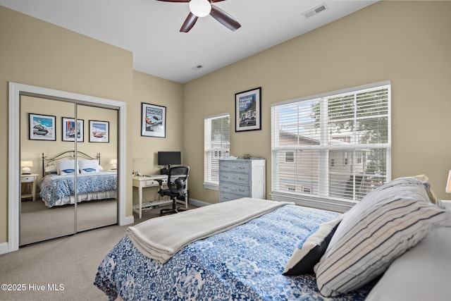 carpeted bedroom with visible vents, ceiling fan, and baseboards