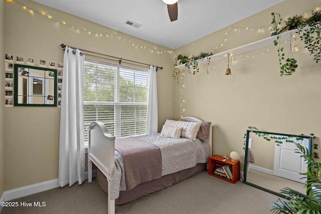 bedroom with baseboards, visible vents, and carpet