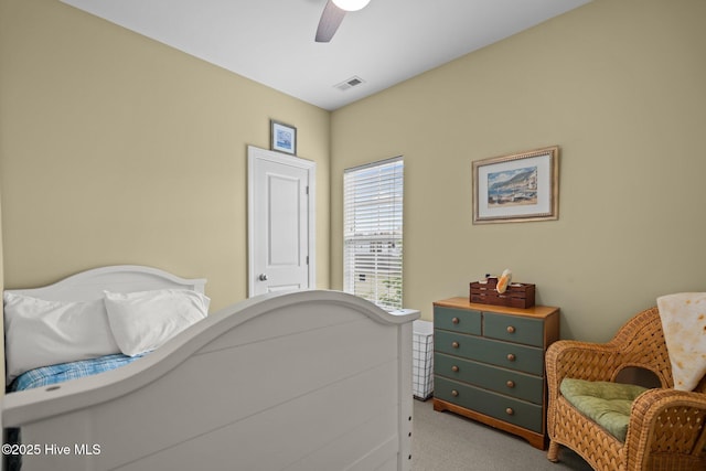 carpeted bedroom with visible vents and ceiling fan