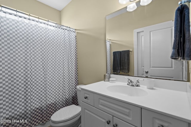 bathroom featuring vanity, toilet, and a shower with shower curtain