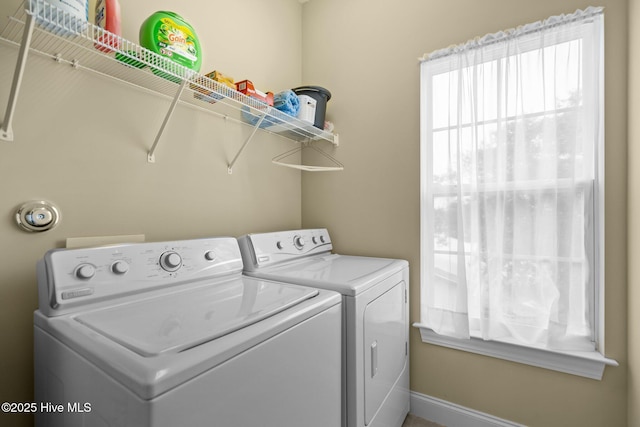 laundry area with baseboards, washing machine and clothes dryer, and laundry area