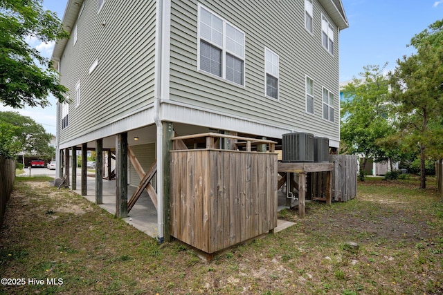 rear view of house featuring central AC