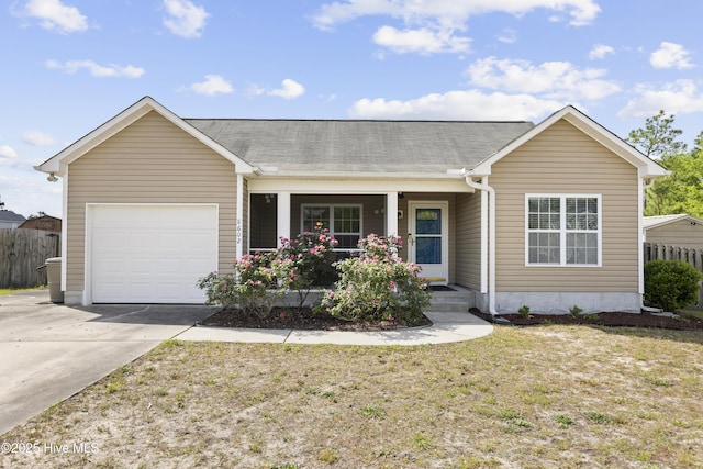 8602 Heirloom Dr NE, Leland, NC 28451 - ranch-style house with fence, a porch, concrete driveway, and an attached garage