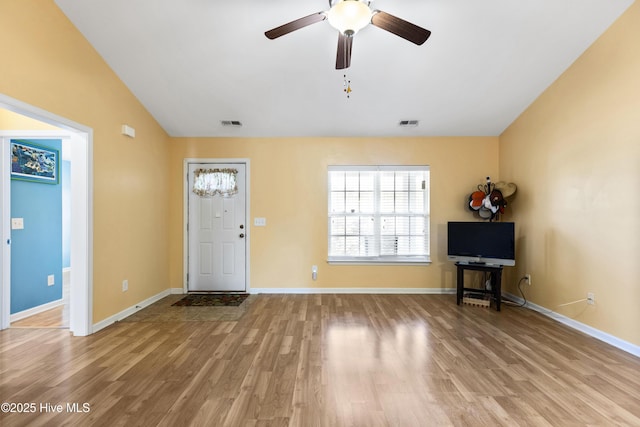 8602 Heirloom Dr NE, Leland, NC 28451 - entryway with lofted ceiling, visible vents, wood finished floors, and baseboards