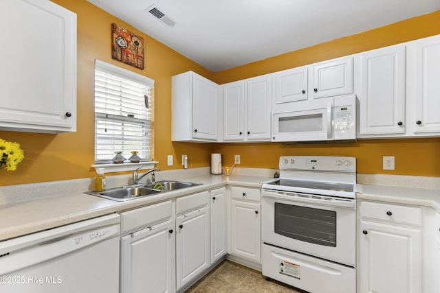 8602 Heirloom Dr NE, Leland, NC 28451 - kitchen with light countertops, a sink, white cabinets, and white appliances