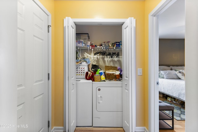 8602 Heirloom Dr NE, Leland, NC 28451 - laundry room with wood finished floors, washer and clothes dryer, and laundry area