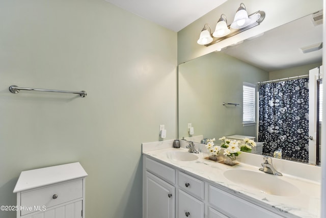 8602 Heirloom Dr NE, Leland, NC 28451 - bathroom with double vanity, visible vents, and a sink
