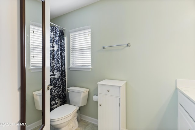 8602 Heirloom Dr NE, Leland, NC 28451 - bathroom featuring toilet, tile patterned flooring, vanity, and baseboards