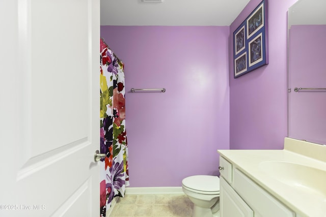 8602 Heirloom Dr NE, Leland, NC 28451 - full bath featuring vanity, curtained shower, toilet, visible vents, and baseboards