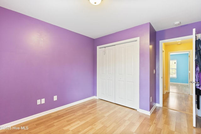 8602 Heirloom Dr NE, Leland, NC 28451 - unfurnished bedroom with baseboards, light wood-type flooring, and a closet
