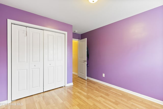 8602 Heirloom Dr NE, Leland, NC 28451 - unfurnished bedroom featuring light wood-style floors, baseboards, and a closet