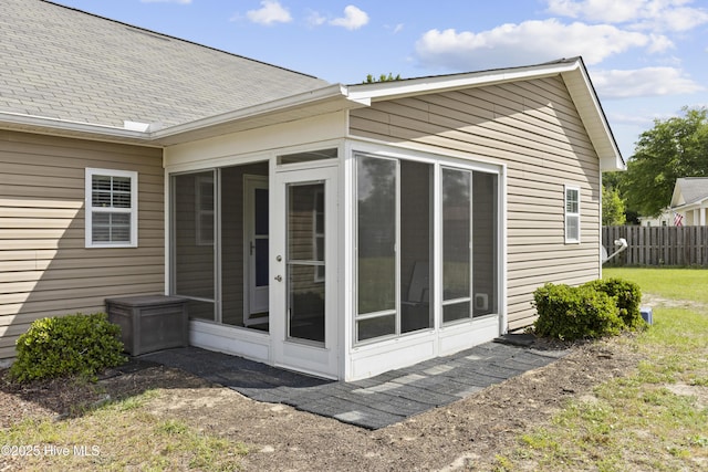 8602 Heirloom Dr NE, Leland, NC 28451 - back of house featuring fence, a sunroom, and roof with shingles